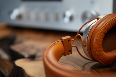 vintage headphones lie on a wooden table.の写真素材