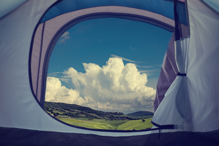 View looking out of door of sun-filled tent upon great outdoors. Tuscanyの写真素材