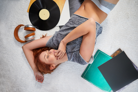 the image of resting sexy woman listening to vinylの写真素材