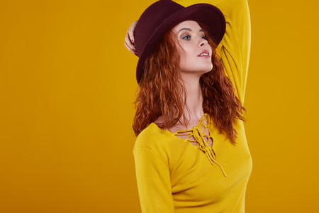 young redhead woman in autumn color isolated on fall  backgroundの写真素材
