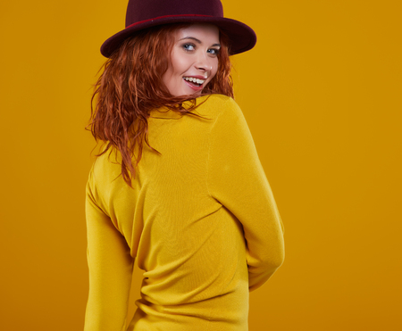 young redhead woman in autumn color isolated on fall  backgroundの写真素材
