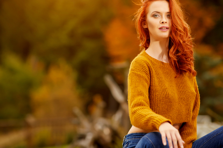 Outdoor atmospheric lifestyle photo of young beautiful lady. Warm autumn.の写真素材