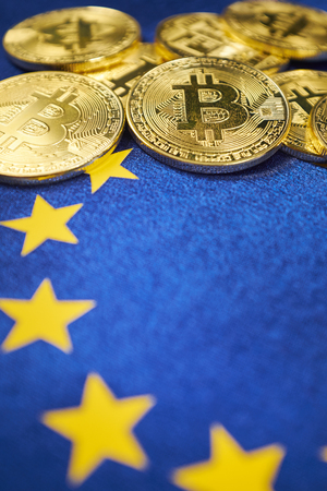 Bitcoin coins against the background of the European Union flag