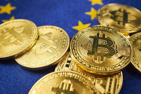 Bitcoin coins against the background of the European Union flag