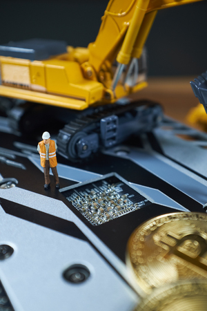 bitcoin mining concept; miniature Excavator and Bitcoin coinsの写真素材