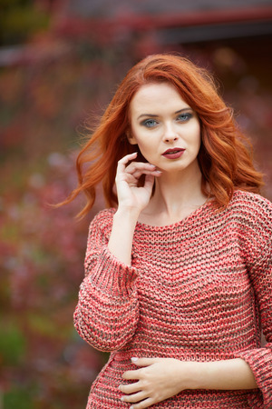 Outdoor  lifestyle photo of young beautiful lady. red hair . Warm autumn. Warm springの写真素材