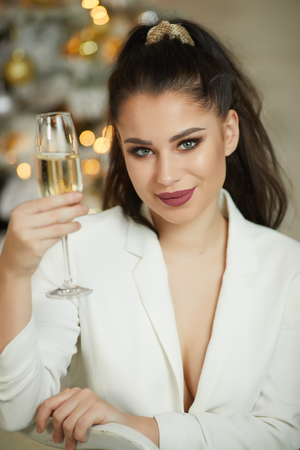 Smiling woman holding glass of sparkling wineの写真素材