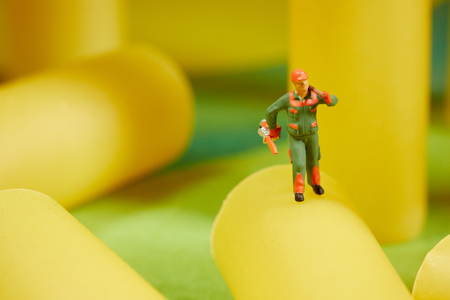 Miniature worker at work. Miniature worker work with spaghettiの写真素材