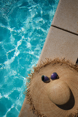 sun hat on the edge of the pool. summer backgroundの写真素材