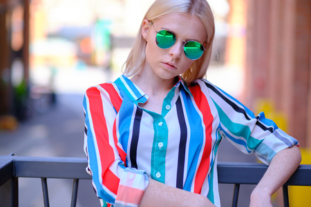 Fashionable girl in a summer shirt on the city streetの写真素材