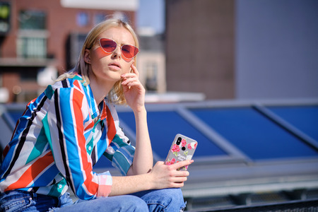 Happy young woman taking selfie on rootfop