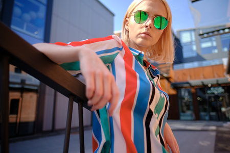 Freckled summer girl is walking in the city streetsの写真素材