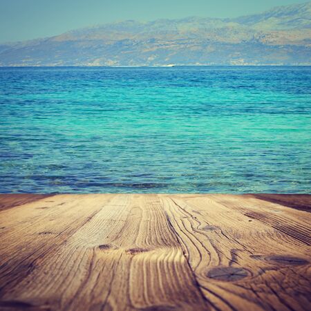 Wood table top on sea beach blurry backgrounds. Abstract backgroundの写真素材