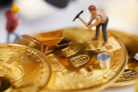 A little miner is digging on graphic card with golden coin. bitcoin mining and crypto currency...