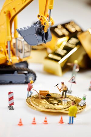 A little miner is digging on graphic card with golden coin. bitcoin mining and crypto currency concept.の写真素材