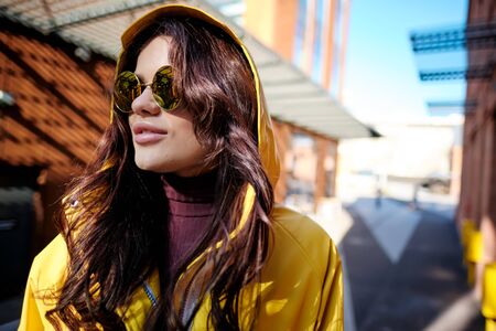 The girl in the yellow coat on the street, stylish outfit, woman fashion, street shootingの写真素材