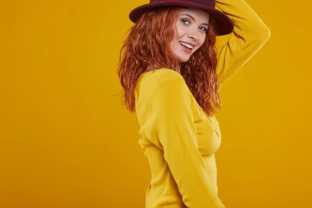 young redhead woman in autumn color isolated on fall  backgroundの写真素材