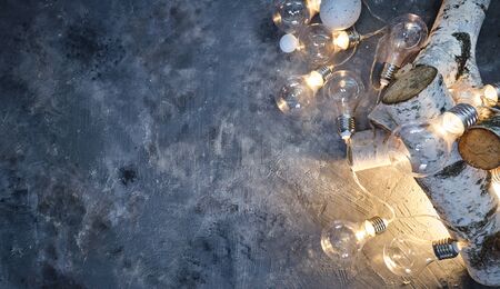 Christmas background with wood tree and decor. Top view with copy space and lighting bulbの写真素材