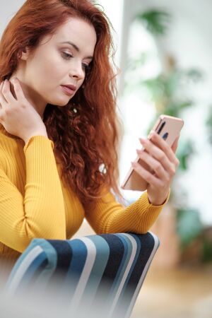 Girl watching a social media live streamの写真素材
