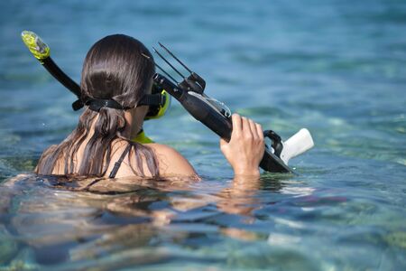 Aqua woman diver spearfishing gun. 