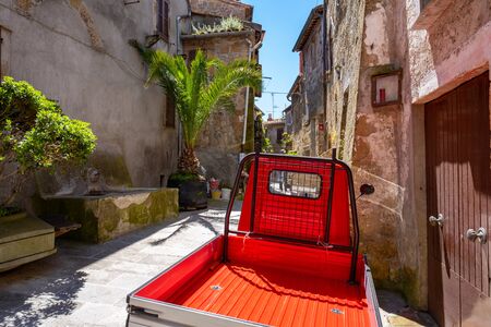 a small truck on the street of an old Italian townの写真素材