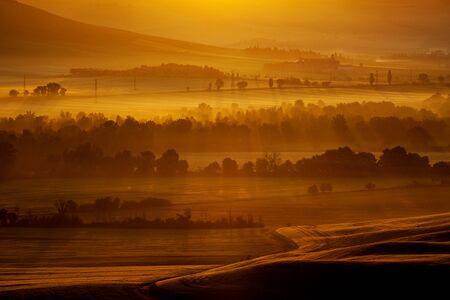 Tuscany landscape at sunrise. Typical for the region tuscan farm house, hills, vineyard. Italyの写真素材