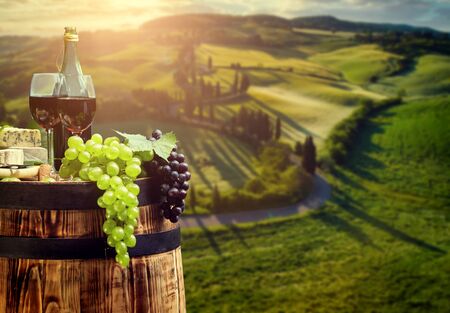 red wine bottle and wine glass on wodden barrelの写真素材