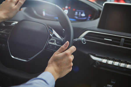 female hands on the steering wheel of a carの写真素材