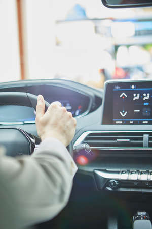 female hands on the steering wheel of a carの写真素材
