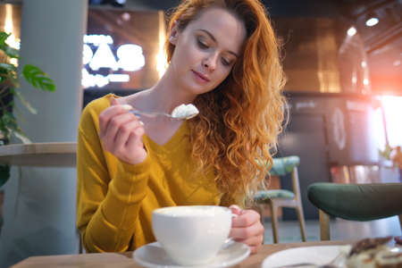 Red-haired Woman in cafe at shopping mallの写真素材