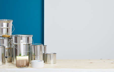 Brushes for painting with paint and cans on a workshop table. Painting accessories prepared for painting.の写真素材