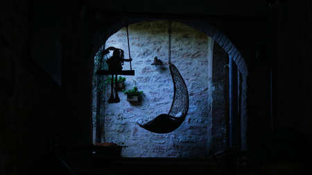 halloween concept. Empty hammock in a dark room. on a swing a doll of a witchの写真素材