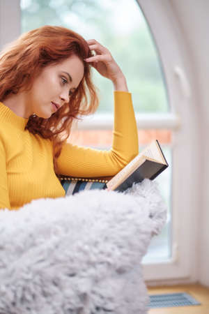 readhead student woman learning and reading books at homeの写真素材