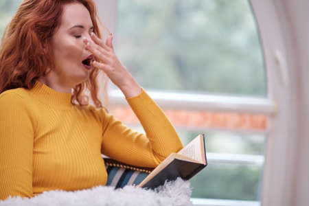 readhead student woman learning and reading books at homeの写真素材