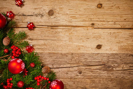 Christmas background with decorations and gift boxes on wooden boardの写真素材