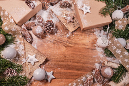 Christmas composition with spruce branch and gifts. wood table. top downの写真素材