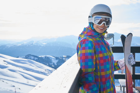 woman skier wearing white healmet with mask in snow winter mountainの写真素材