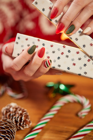 Female hands, Christmas gift, fancy manicureの写真素材