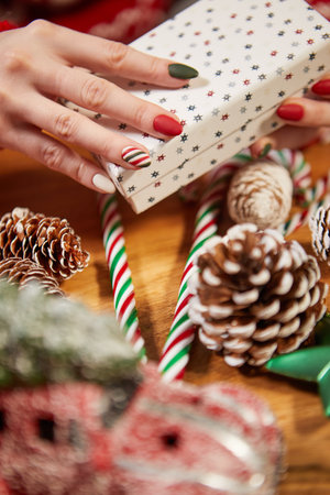 Female hands, Christmas gift, fancy manicureの写真素材