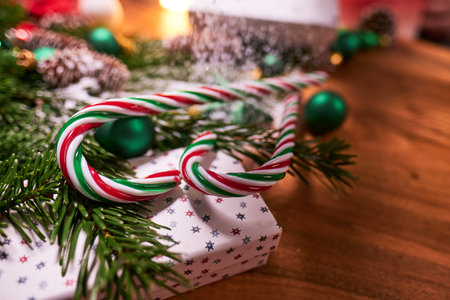 Christmas dark background with christmas decoration, christmas candy canes, fir branch, top viewの写真素材