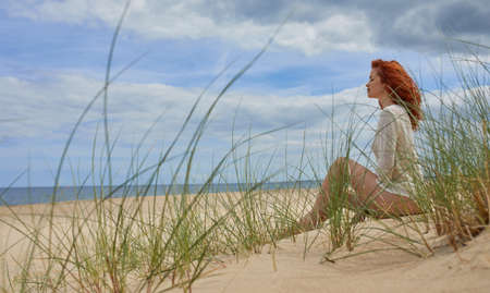 Girl sunbathing on white sand beachの写真素材