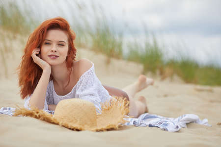Beautiful woman in bikini sunbathing at the seasideの写真素材