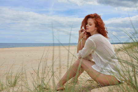 Girl sunbathing on white sand beachの写真素材