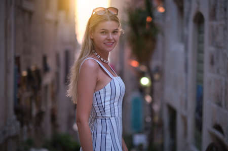 Fashionably dressed woman on the streets of a small Italian townの写真素材