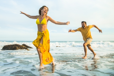 Man chasing woman at the beach