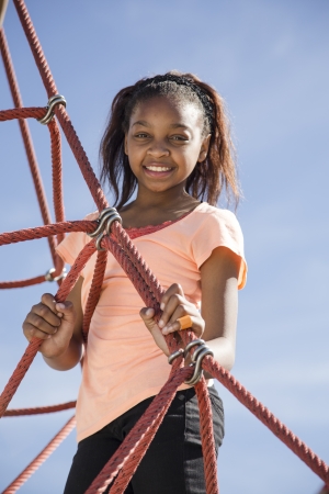 Young girl playing on web climberの写真素材