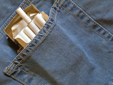 Cigarettes pack within back pocket of blue jeansの写真素材