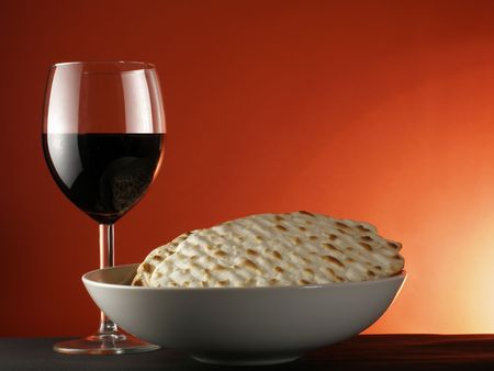 Wine and matzoh over red backgroundの写真素材