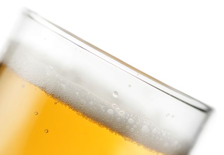 Glass of beer with froth super close-up