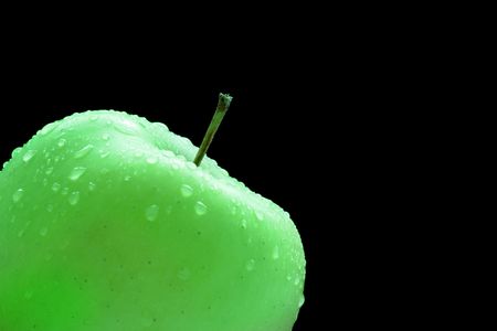 Granny smith apple isolated over a black backgroundの写真素材